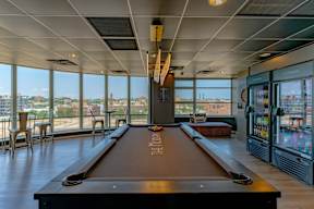 A pool table in a room with a view of the city.