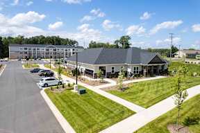 A large building with a parking lot in front of it.