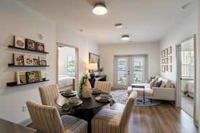 A dining room with a table set for six.