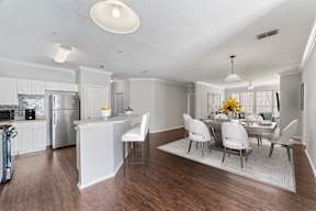 A modern kitchen with a dining table set for four.