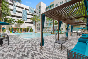 a swimming pool with a blue couch and a table