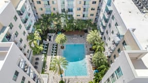 an overhead view of a swimming pool in the middle of an apartment building