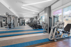 a fitness center with cardio equipment and weights in a gym