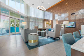 the lobby of a holiday inn hotel with chairs and tables