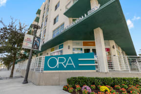 a sign for the ora hotel in front of a building