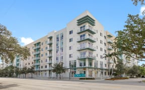 a white apartment building with a street in front of it