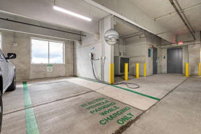 a clean garage with a car and a hose on the floor