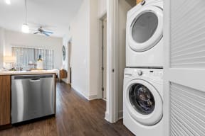 a washer and dryer in a living room with a kitchen