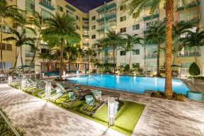 a swimming pool at a resort with palm trees