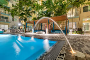 a large swimming pool with a water fountain
