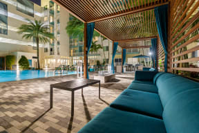 a lounge area with a blue couch and a table