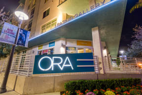 the facade of the ora building at night