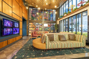 a lobby with two chairs and a wall of windows