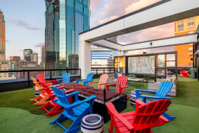 a terrace with red and blue chairs and a table