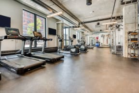 the gym with treadmills and weights at the belgard apartments