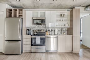 a kitchen with stainless steel appliances and white cabinets