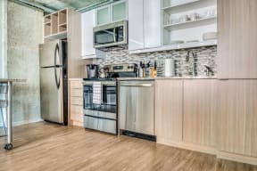 a kitchen with stainless steel appliances and wooden cabinets
