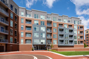 a large apartment building with a basketball court in front of it