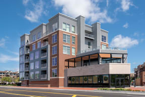 a rendering of a large apartment building on a city street