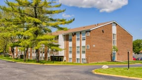 a large brick building with a street in front of it
