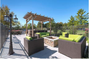 a patio with furniture and a fire pit