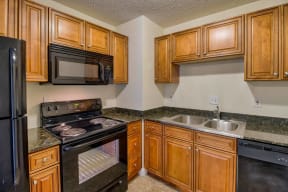 a kitchen with a stove microwave and sink