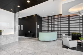 a lobby with a reception desk and chairs
