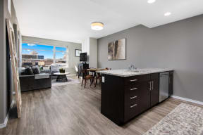 an open living room and kitchen with a view of the city