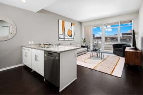 a kitchen with an island and a living room with a large window