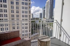 a balcony with a view of the city and a red carpet