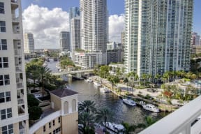 a view of the city from a balcony with boats in a river