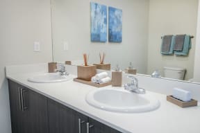 a bathroom with two sinks and a mirror