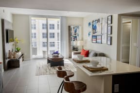 a living room and dining room with a table and chairs