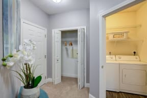 a laundry room with a washer and dryer and a closet