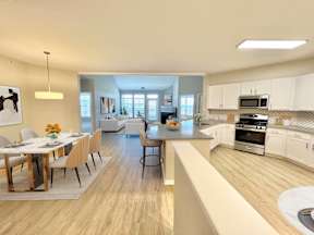 A modern kitchen with a dining table set for four.