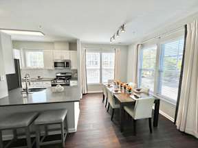 A modern kitchen with a dining table set for four.