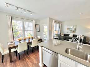 A modern kitchen with a dining table and chairs.