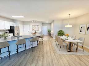 A kitchen with a bar area and a dining table.
