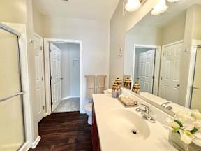 A bathroom with a white sink and a mirror.