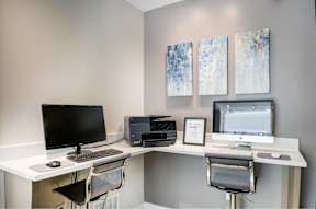 A white desk with a computer monitor, keyboard, and mouse.
