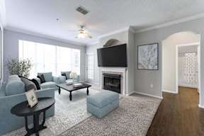 A living room with a fireplace and a television.