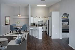 A modern kitchen with a dining table and chairs.