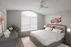 A bedroom with a large bed, a ceiling fan, and a painting of flowers on the wall.