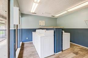 A room with a washer and dryer set up.