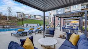 Ample seating and lounge chairs surrounding The Artisan at Robinson's community pool