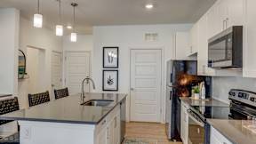 Modern apartment kitchens with islands inside homes at The Artisan at Robinson Apartments