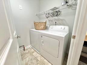 A small laundry room with a washer and dryer.
