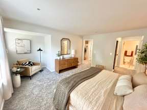 A bedroom with a large bed and a couch.