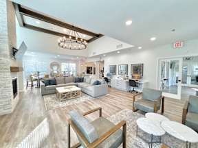 A spacious living room with a fireplace and a variety of seating options.