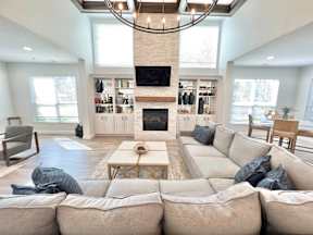 A living room with a fireplace and a large couch.